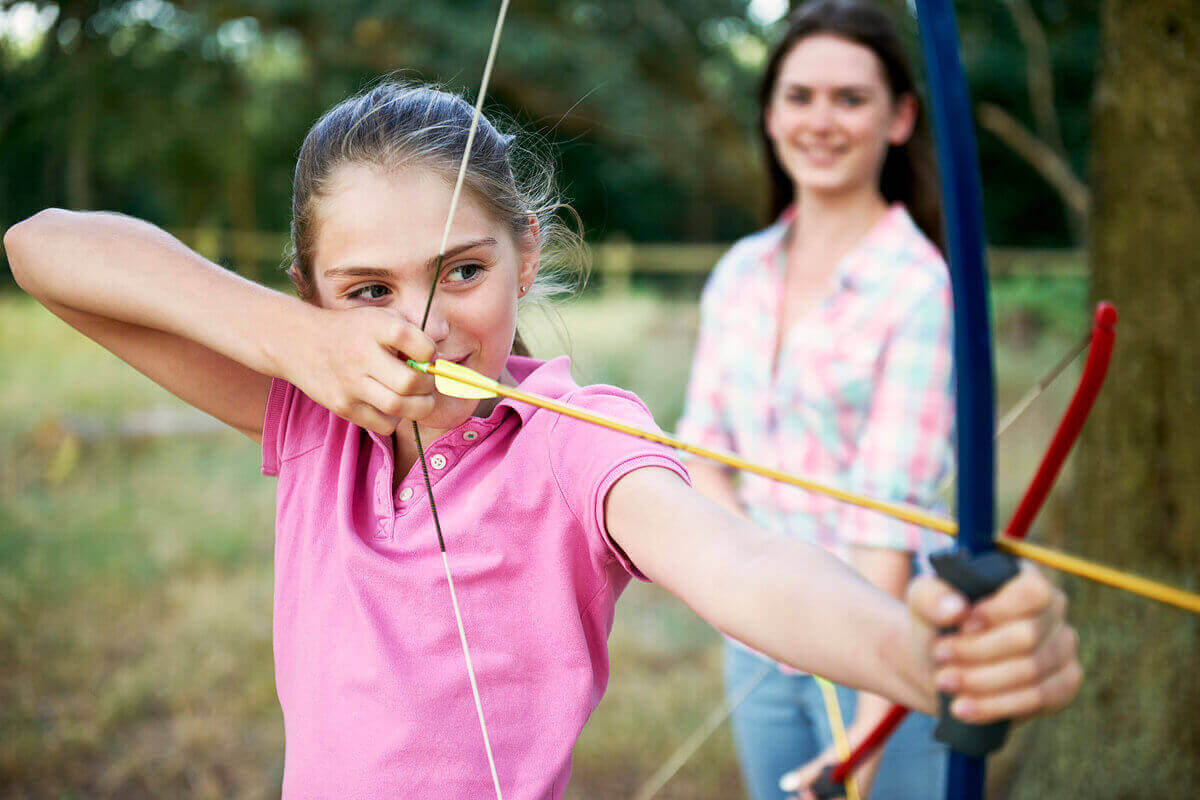 girl-practicing-archery-aiming-with-bow-and-arrow-2022-03-07-23-54-26-utc